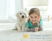 child and dog on carpet