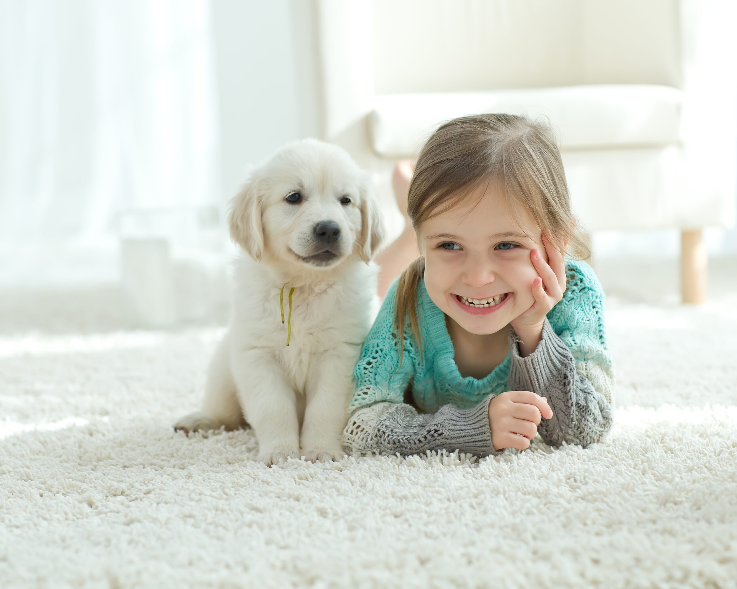 child and dog on carpet