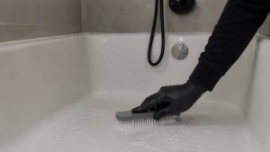 Scrubbing a Soapy White Bathtub